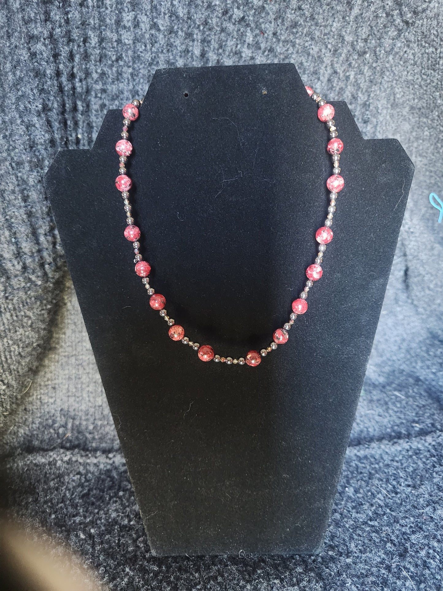 Red Jasper with Hematite and acrylic accents.