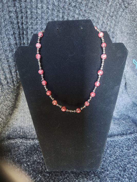 Red Jasper with Hematite and acrylic accents.